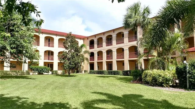 a front view of residential houses with yard and green space