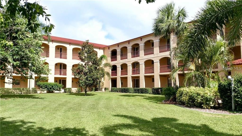 1 Colony Point Drive, Unit A5 Punta Gorda, FL 33950 - Photo 2 of 37 a front view of residential houses with yard and green space