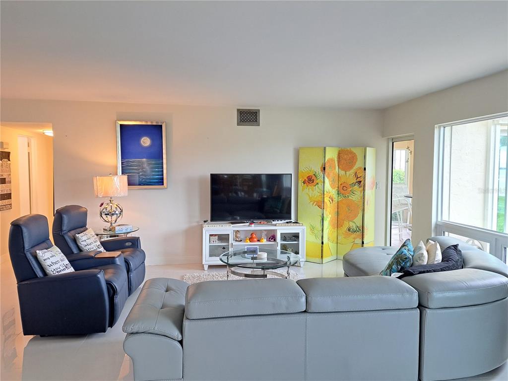 1 Colony Point Drive, Unit A5 Punta Gorda, FL 33950 - Photo 25 of 37 a living room with furniture and a flat screen tv