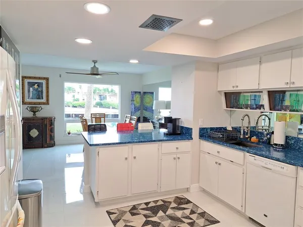 a kitchen with granite countertop a sink and cabinets