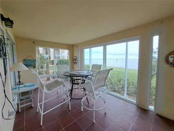 a view of a dining room with furniture large windows and wooden floor
