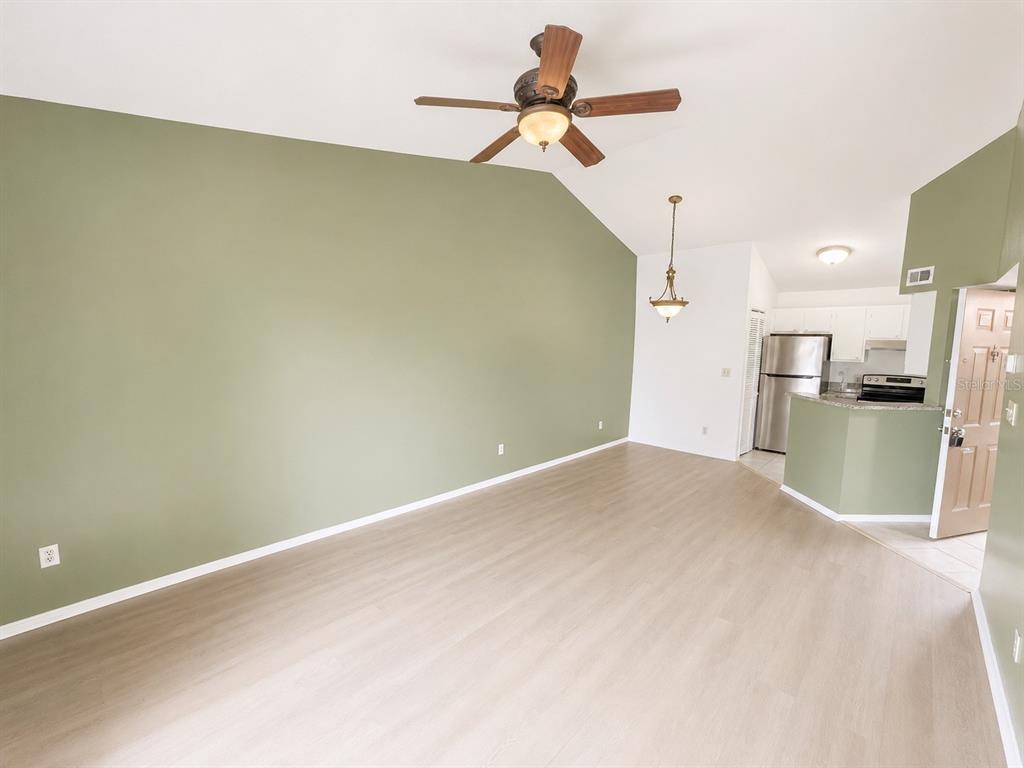 1908 Lake Atriums Circle, Unit 9 Orlando, FL 32839 - Photo 5 of 11 a view of a kitchen with a sink and a refrigerator
