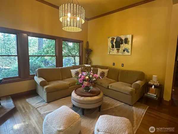 a living room with fireplace furniture and a chandelier