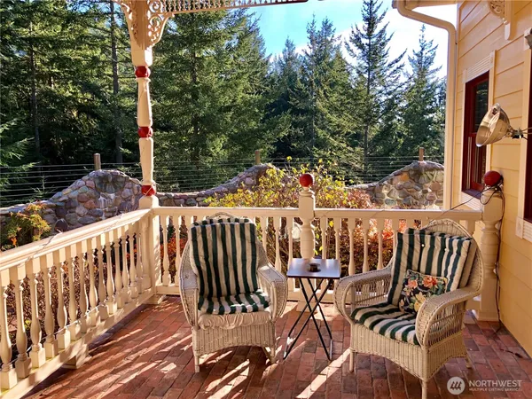 a view of a wooden chairs on the deck