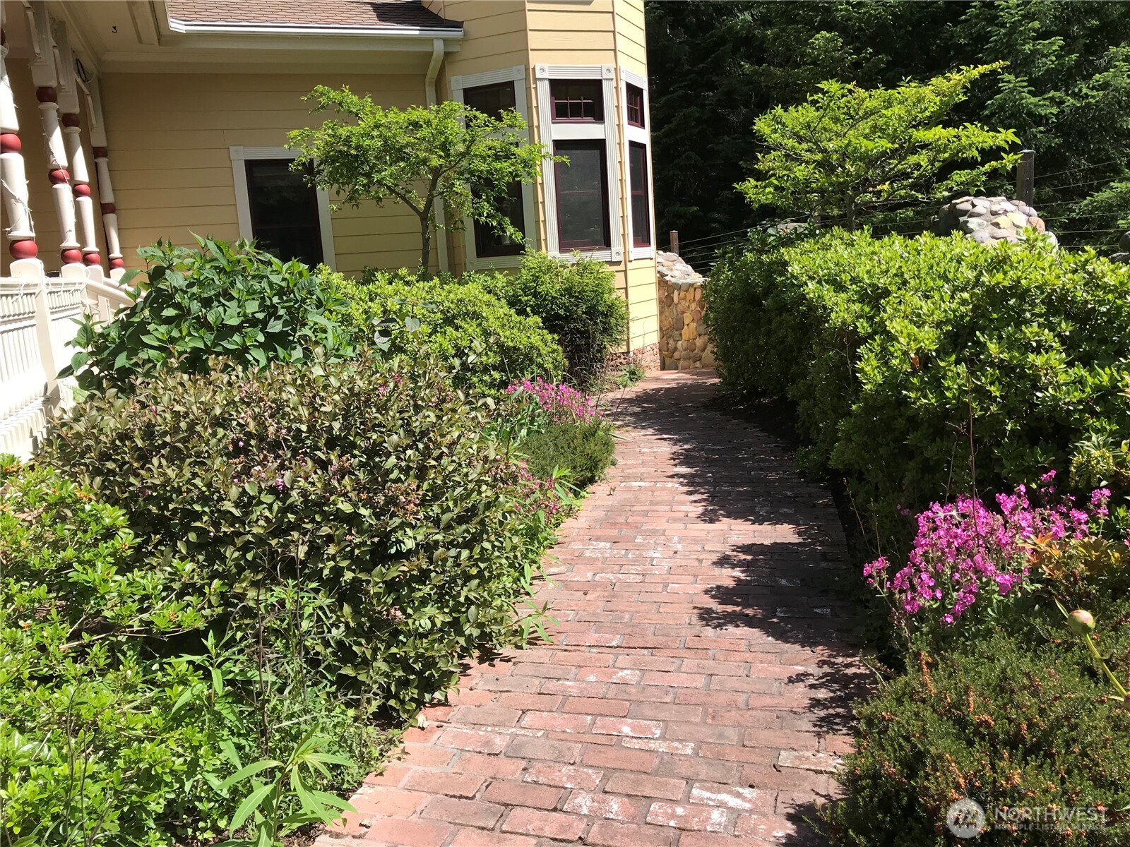 1656 Eagle Ridge Road Orcas Island, WA 98245 - Photo 9 of 40 a front view of a house with a yard and flowers
