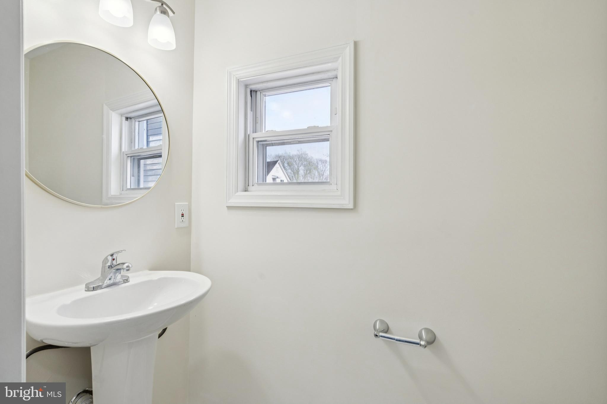 457 Wesley Avenue Pitman, NJ 08071 - Photo 14 of 25 a bathroom with a sink and a mirror