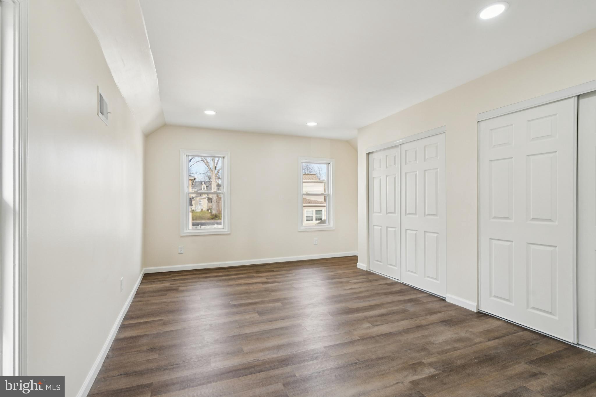 457 Wesley Avenue Pitman, NJ 08071 - Photo 15 of 25 a view of an empty room with wooden floor and a window