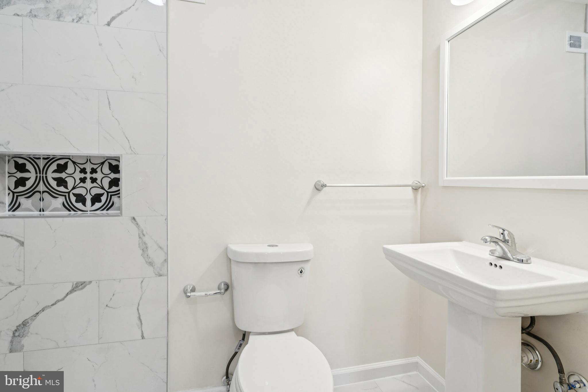457 Wesley Avenue Pitman, NJ 08071 - Photo 17 of 25 a bathroom with a toilet sink and mirror