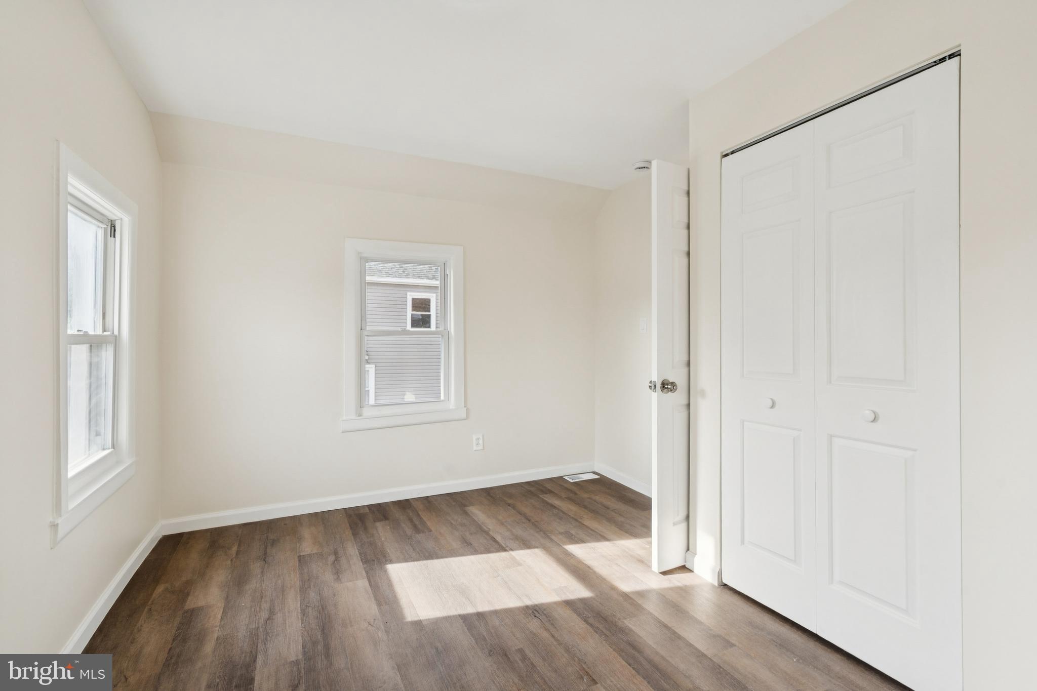 457 Wesley Avenue Pitman, NJ 08071 - Photo 20 of 25 an empty room with wooden floor and windows