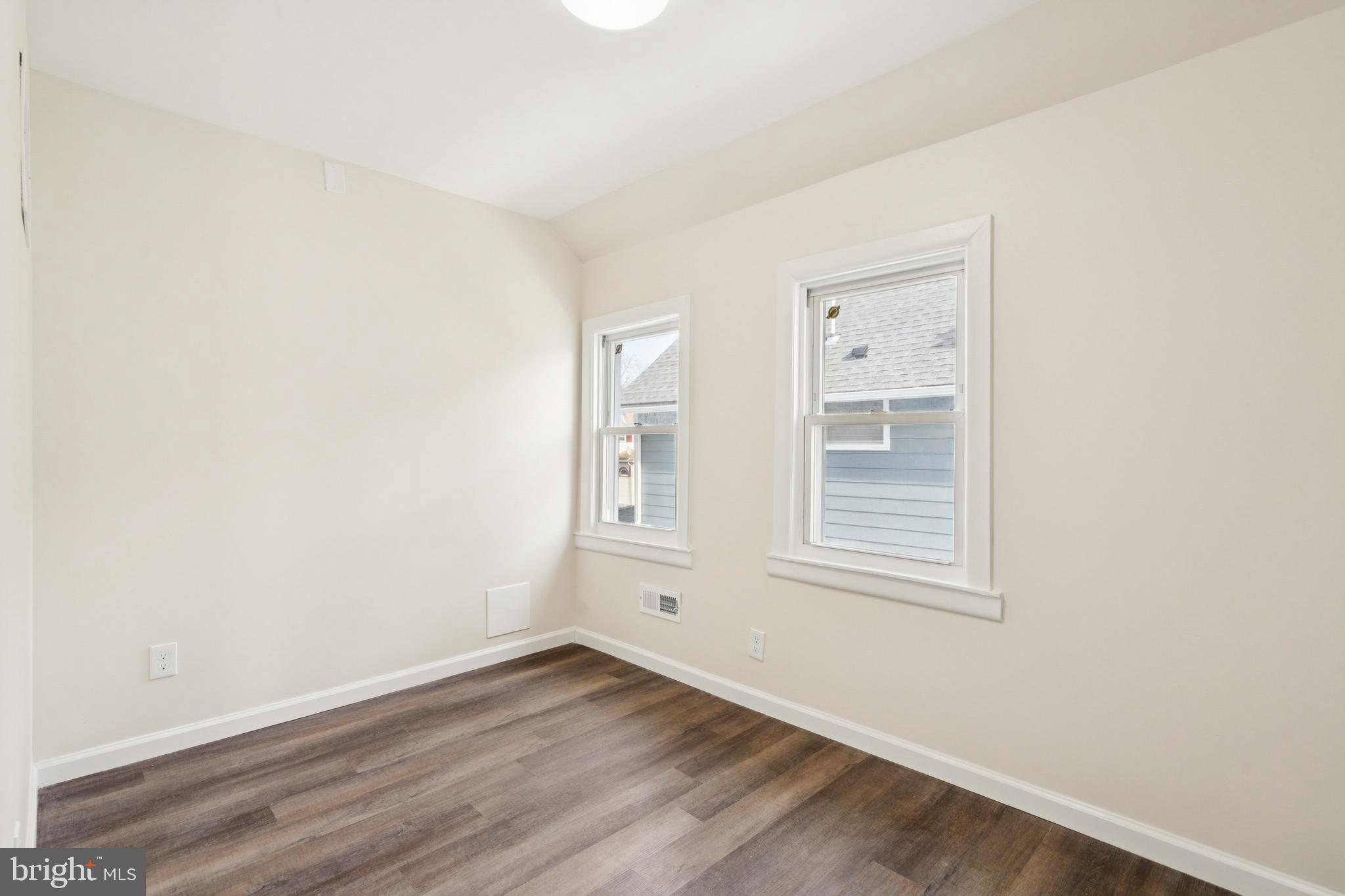 457 Wesley Avenue Pitman, NJ 08071 - Photo 21 of 25 an empty room with wooden floor and windows