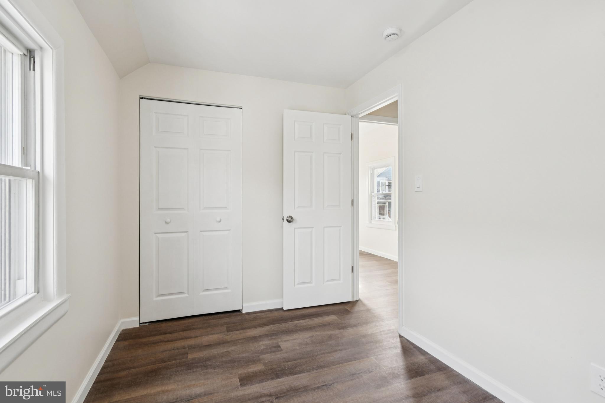457 Wesley Avenue Pitman, NJ 08071 - Photo 22 of 25 a view of an empty room with wooden floor and a window