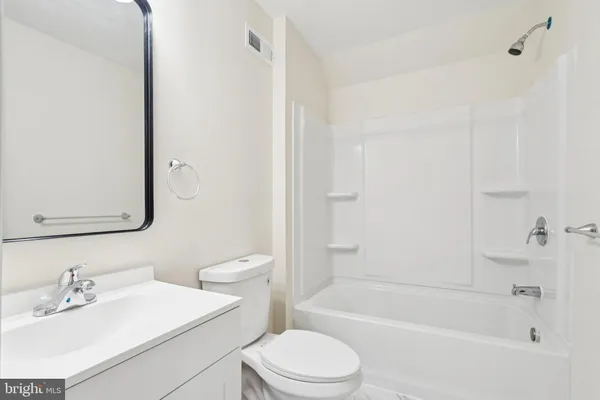 a bathroom with a sink a toilet and a bathtub