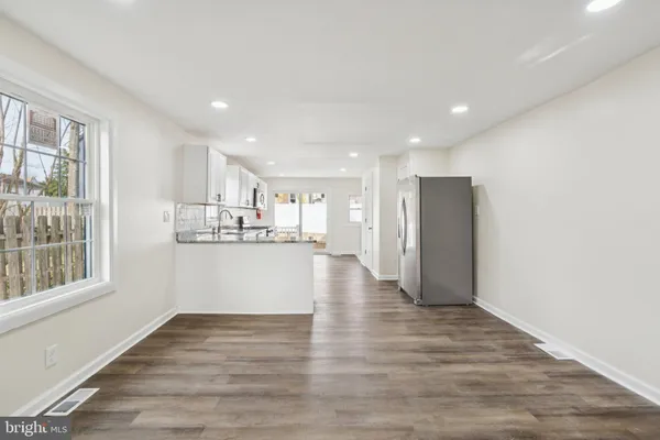 a view of a kitchen with wooden floor