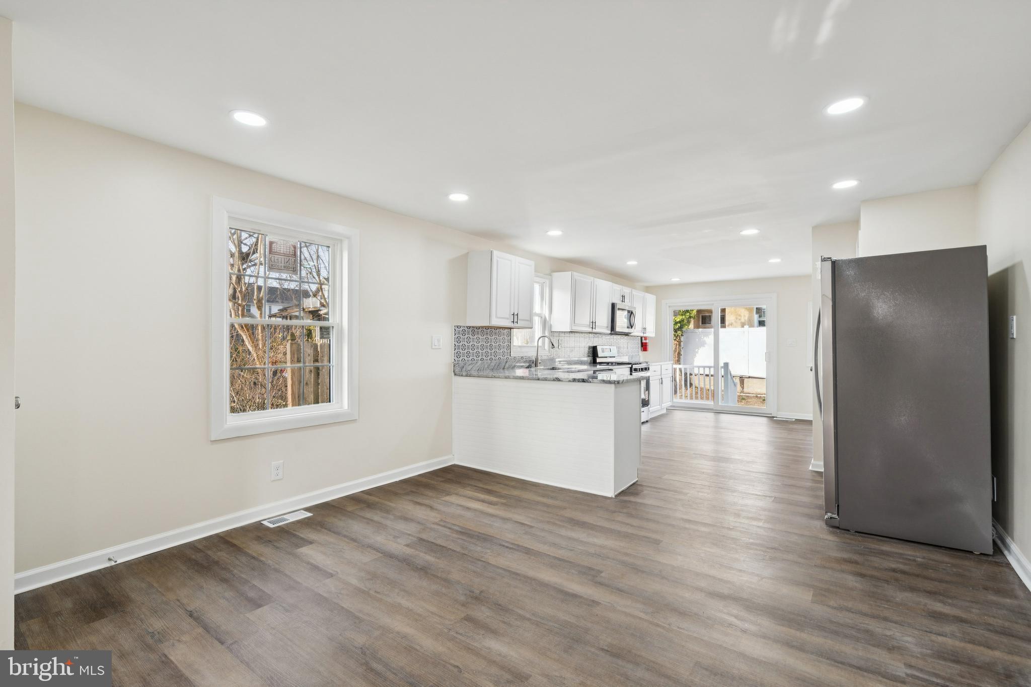 457 Wesley Avenue Pitman, NJ 08071 - Photo 9 of 25 a view of a kitchen with a refrigerator and wooden floor