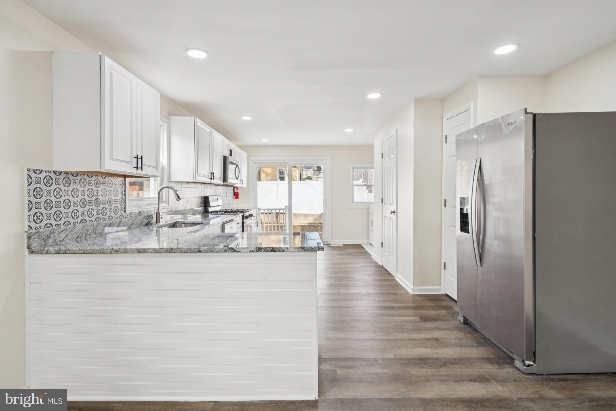 457 Wesley Avenue Pitman, NJ 08071 - Photo 10 of 25 a kitchen with stainless steel appliances granite countertop a refrigerator a sink and white cabinets