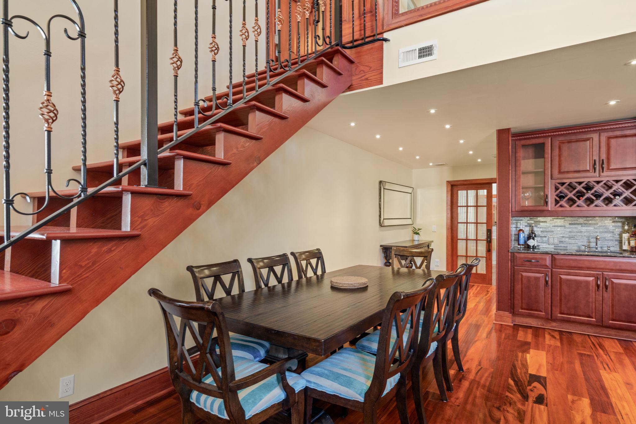 802 Locust Street, Unit 201 Philadelphia, PA 19107 - Photo 18 of 53 Elegant dining space with staircase charm.