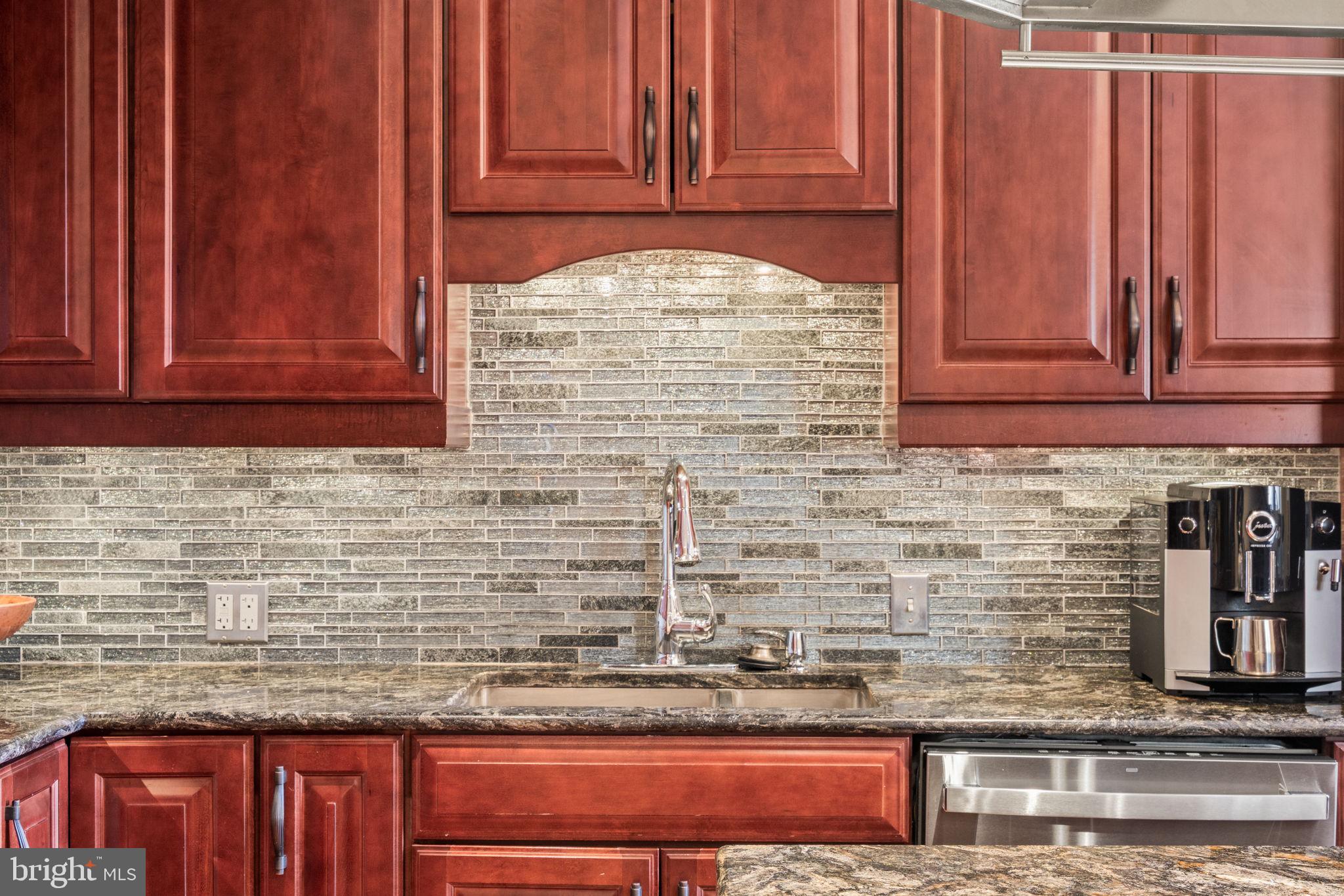 802 Locust Street, Unit 201 Philadelphia, PA 19107 - Photo 7 of 53 Elegant kitchen with rich wood accents.