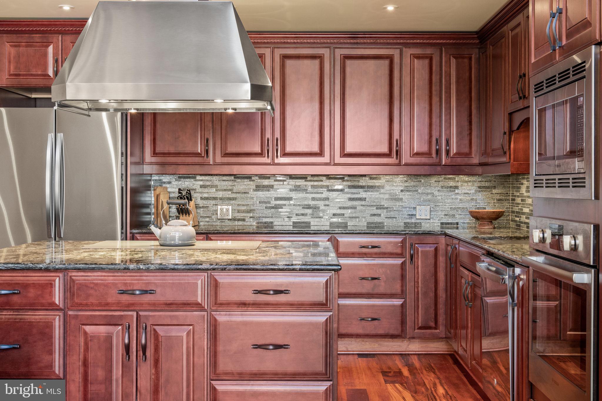 802 Locust Street, Unit 201 Philadelphia, PA 19107 - Photo 8 of 53 Elegant kitchen with rich wood tones.
