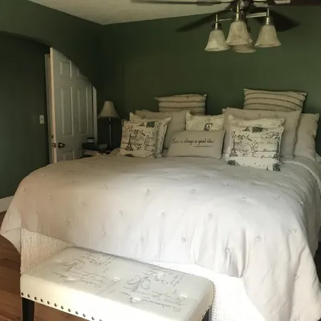 a bed sitting in a bedroom next to a window