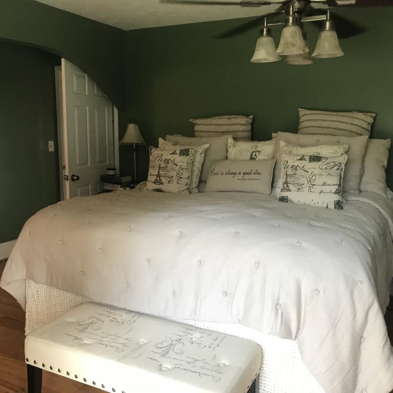 a bed sitting in a bedroom next to a window