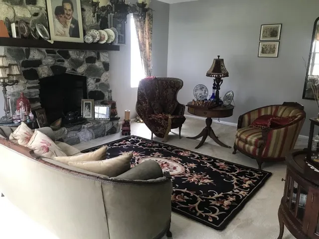 a living room with furniture and a fireplace