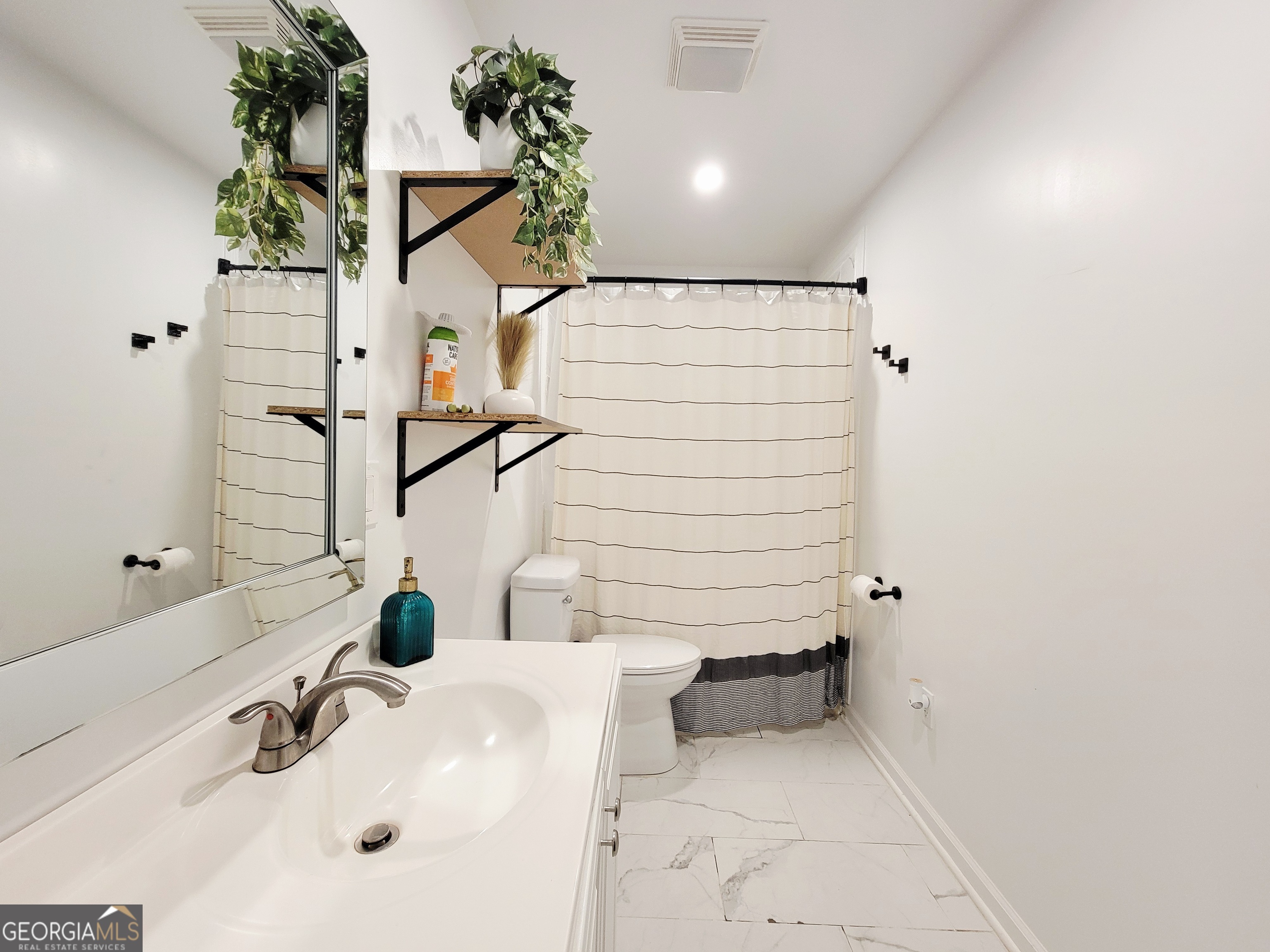 524 Louina Road Roanoke, AL 36274 - Photo 16 of 24 a bathroom with a sink and a mirror