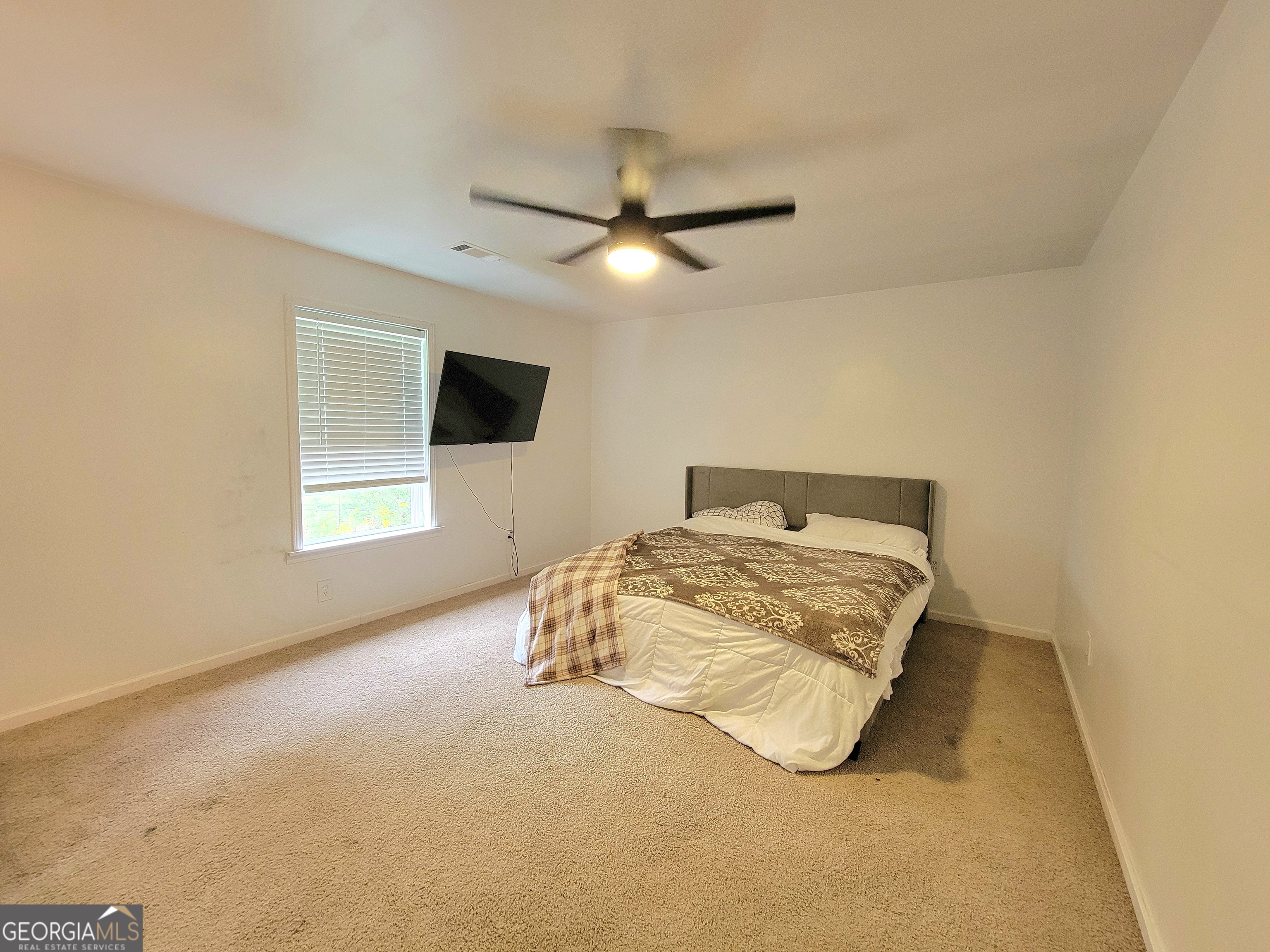 524 Louina Road Roanoke, AL 36274 - Photo 19 of 24 a bedroom with a bed and a ceiling fan