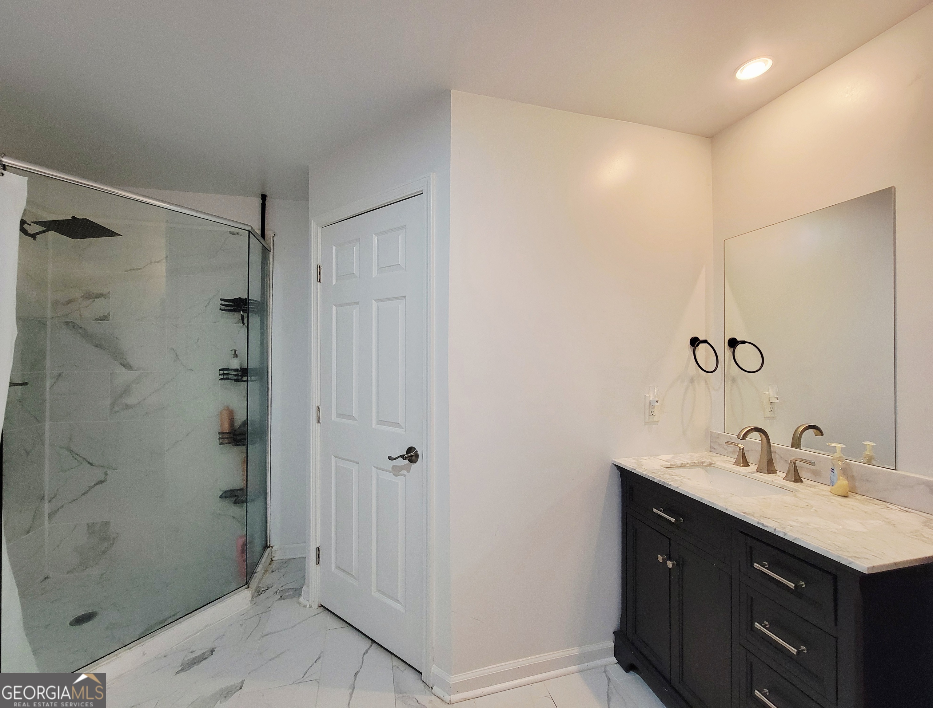 524 Louina Road Roanoke, AL 36274 - Photo 22 of 24 a bathroom with a shower sink vanity and mirror