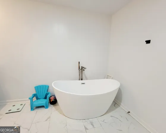 a white bath tub sitting in a bathroom