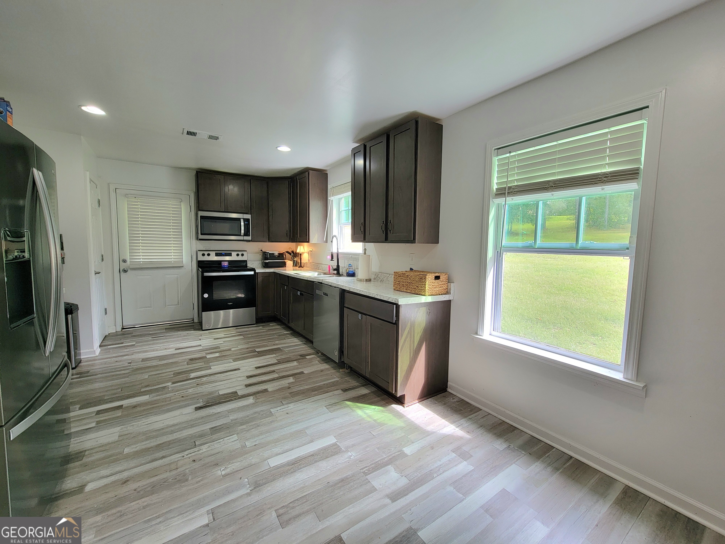 524 Louina Road Roanoke, AL 36274 - Photo 5 of 24 a kitchen with stainless steel appliances granite countertop a stove a sink and a refrigerator