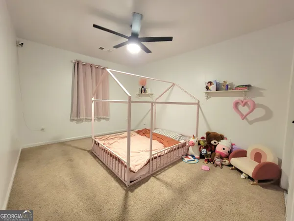 a room with toys and a chandelier fan