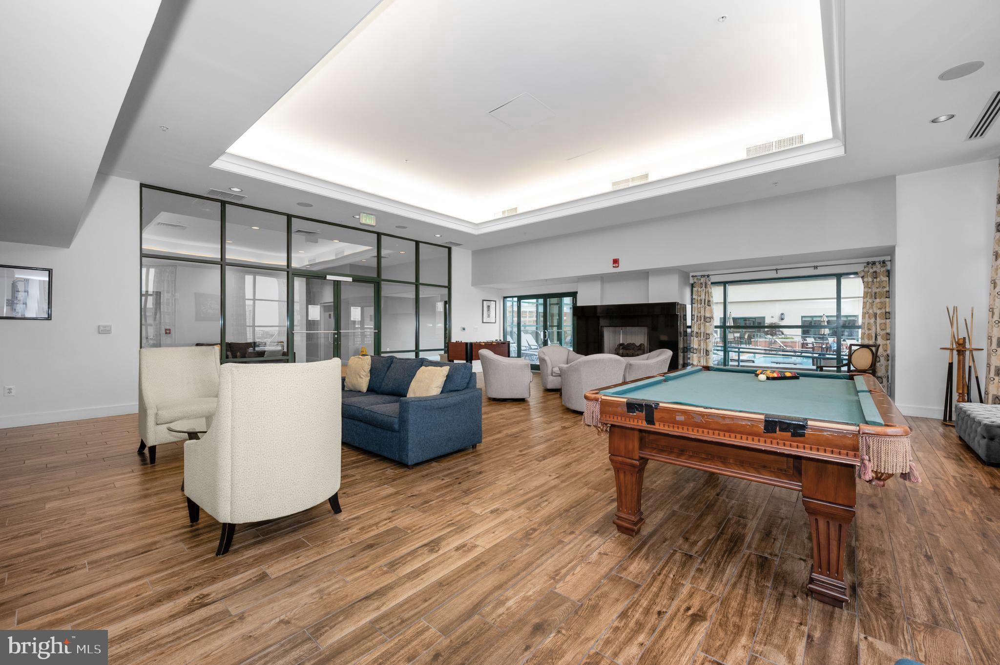 414 Water Street, Unit 2805 Baltimore, MD 21202 - Photo 21 of 24 a living room with furniture a flat screen tv and a wooden floor