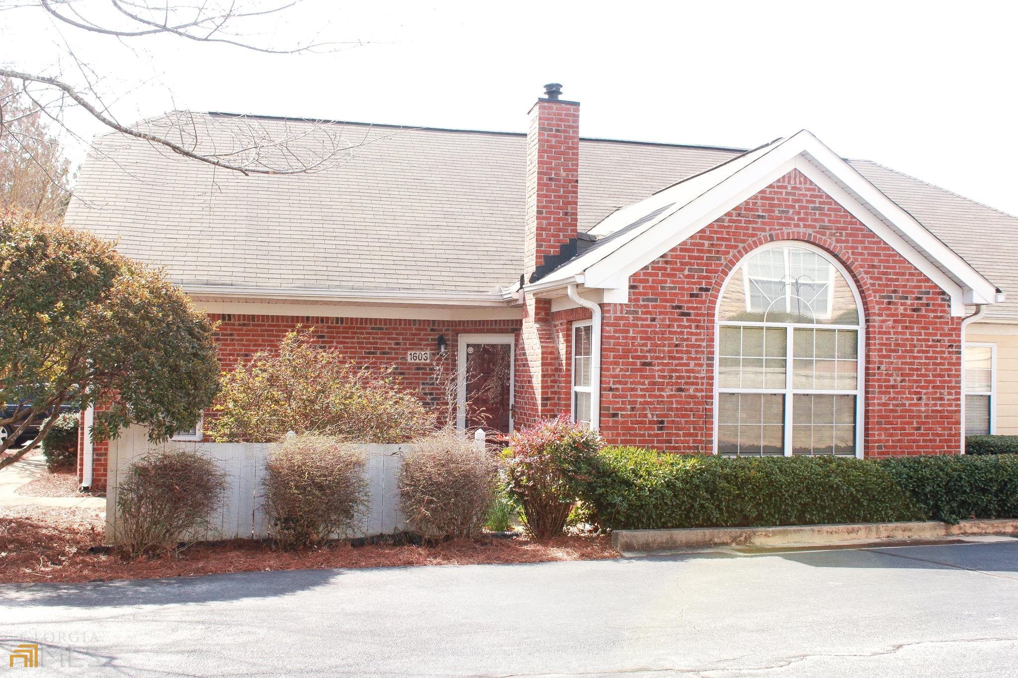 2191 Rockbridge Road, Unit 1603 Stone Mountain, GA 30087 - Photo 1 of 1 a front view of a house with a yard