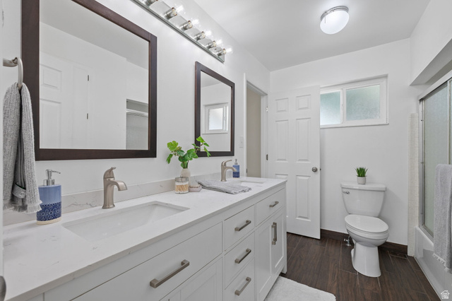 2370 Quail Run Circle East Sandy, UT 84093 - Photo 16 of 54 Bathroom featuring a dual vanity with white cabinetry, integrated sinks, and brushed nickel hardware