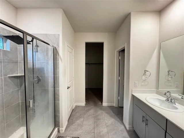 a bathroom with a double vanity sink mirror and shower