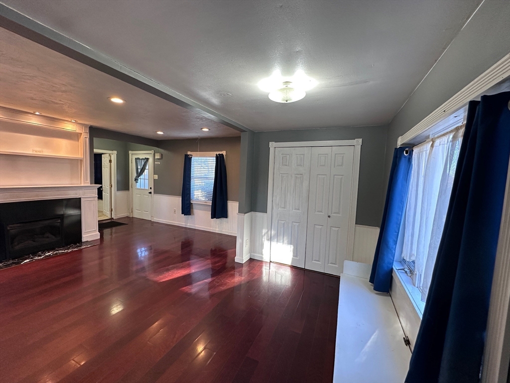 4 Martin Street Wareham, MA 02532 - Photo 8 of 33 a view of an empty room with wooden floor and a fireplace