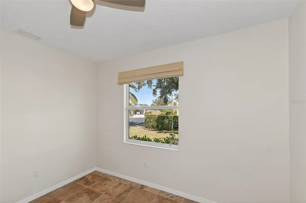 a view of an empty room with cabinet and entryway