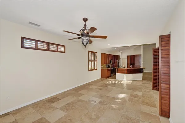 a kitchen with kitchen island granite countertop a sink and refrigerator