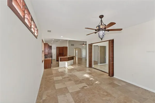 a large kitchen with granite countertop a stove and cabinets