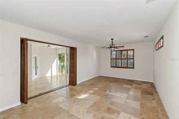 a kitchen with stainless steel appliances granite countertop a refrigerator a stove a sink a oven with a dining table and chairs