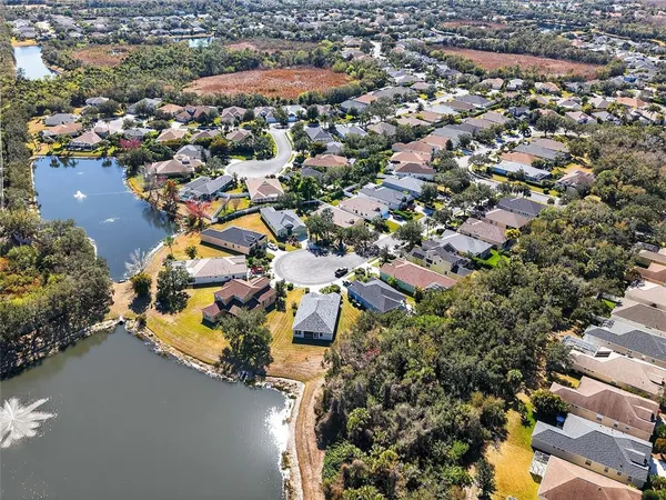 an aerial view of a house with a garden and trees