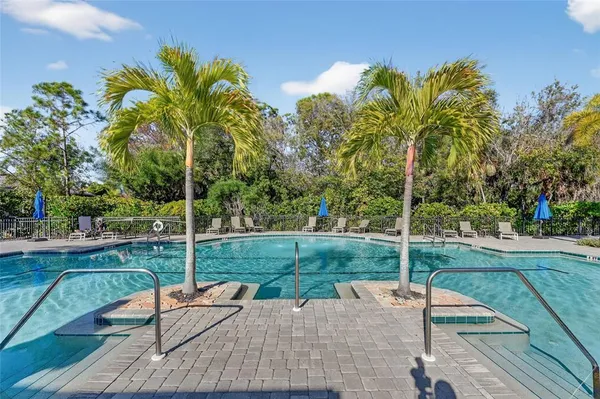 an aerial view of a house with yard swimming pool and outdoor seating