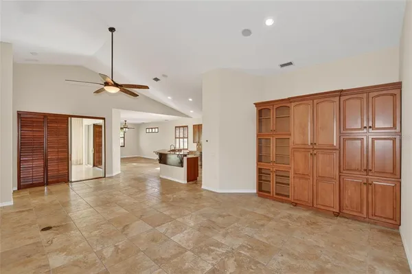 a view of empty room with window and wooden floor