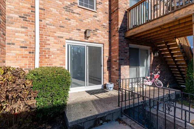 a view of house with backyard and sitting area