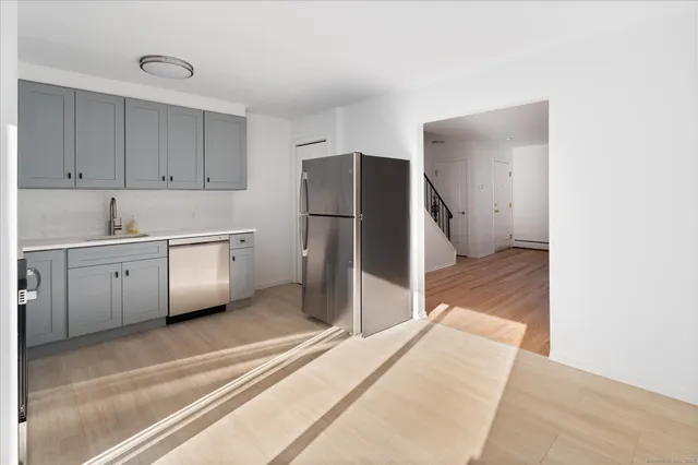 a kitchen with a sink and refrigerator