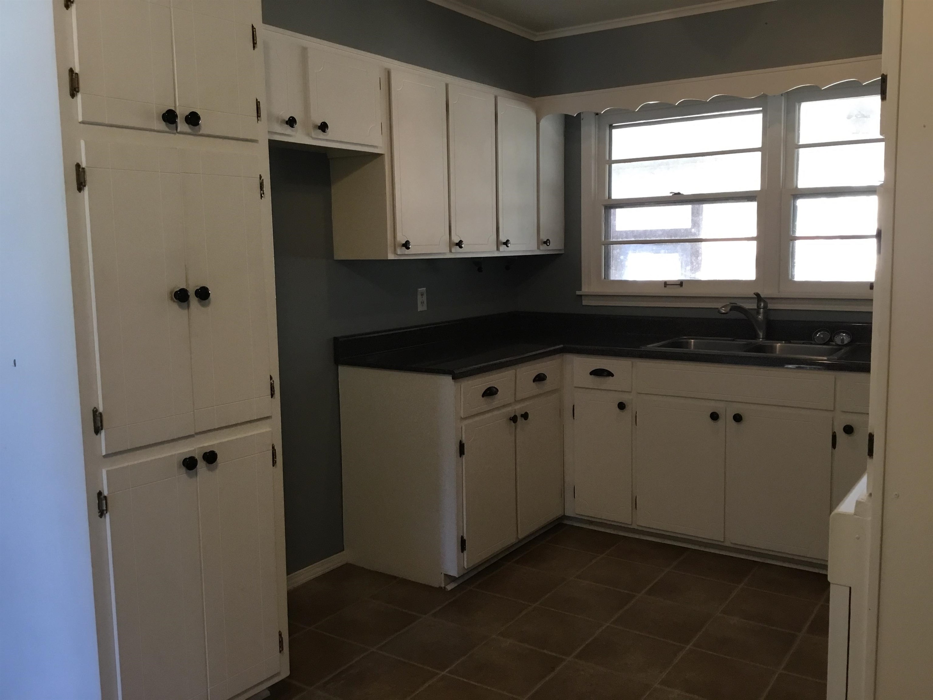 47735 69th Highway Saltillo, TN 38370 - Photo 6 of 21 a kitchen with white cabinets and a window