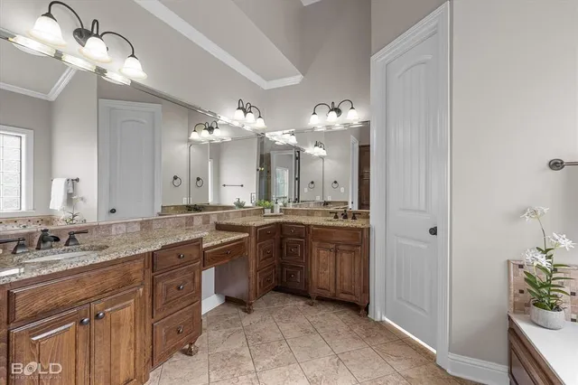 a bathroom with a sink a large mirror and a bathtub