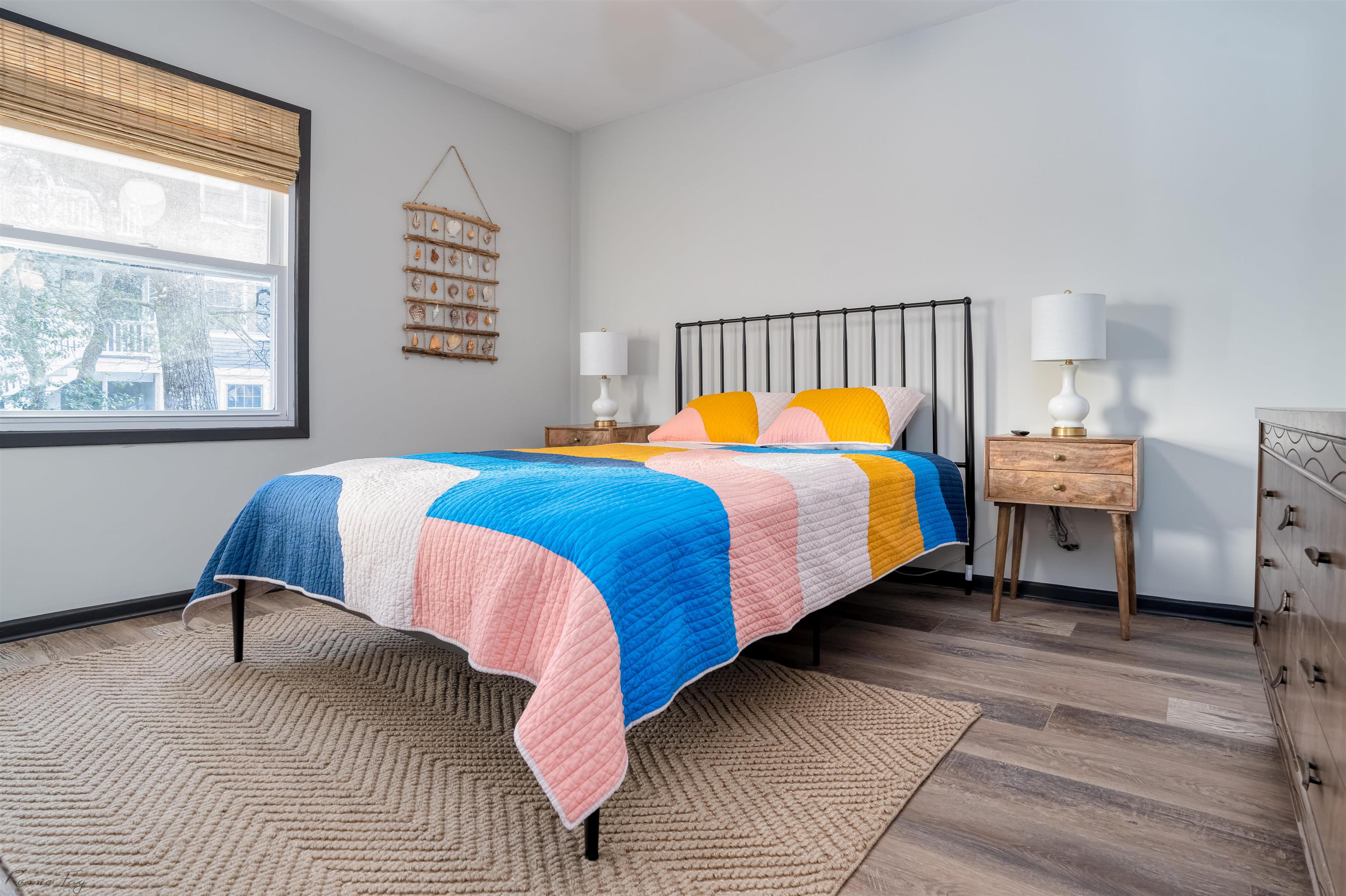 512 Robin Cape Villas, NJ 08251 - Photo 13 of 18 a bedroom with a bed a chair and a large window