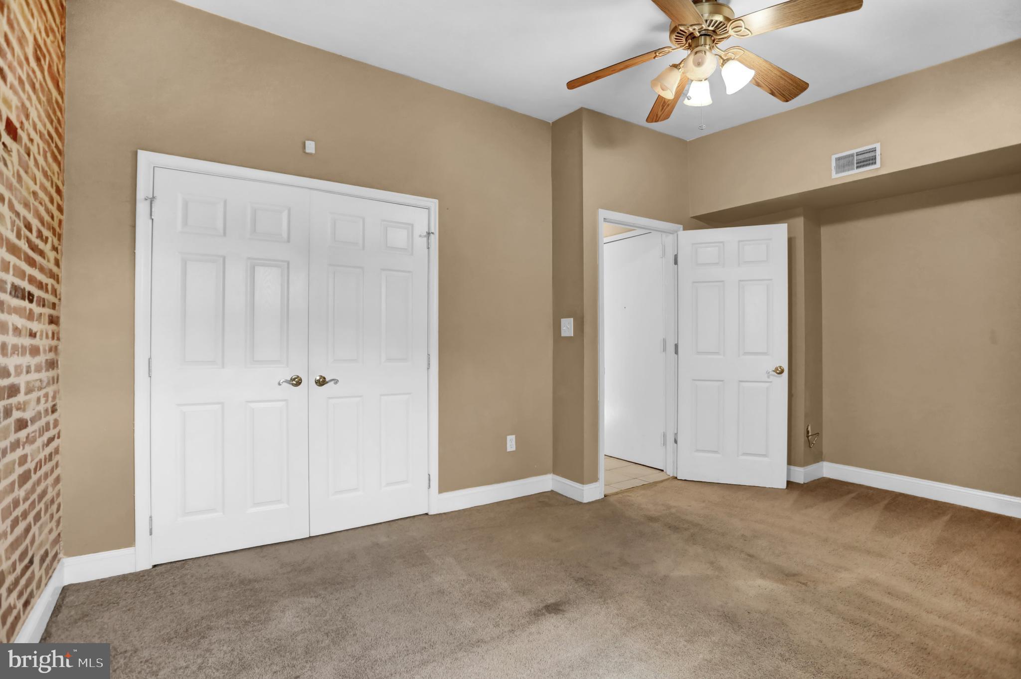 1103 Light Street, Unit B Baltimore, MD 21230 - Photo 15 of 23 an empty room with a chandelier fan and closet area