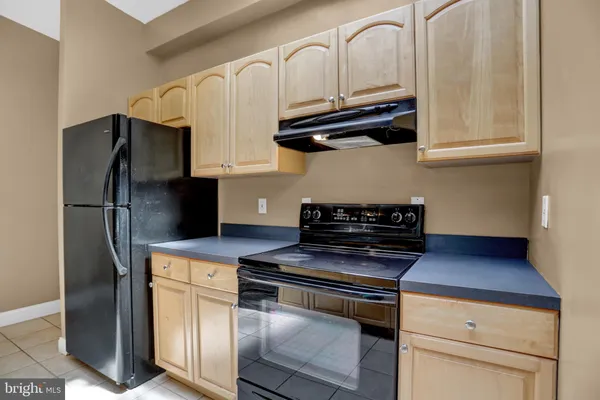 a kitchen with stainless steel appliances a refrigerator a stove and cabinets